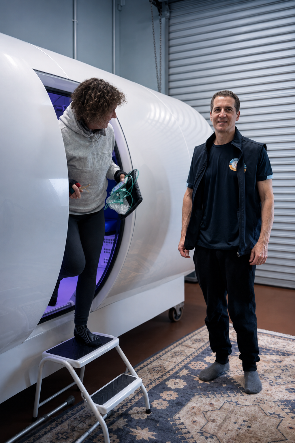 Dr Mark Farrell beside a patient leaving a hyperbaric chamber at Wellington Hyperbarics